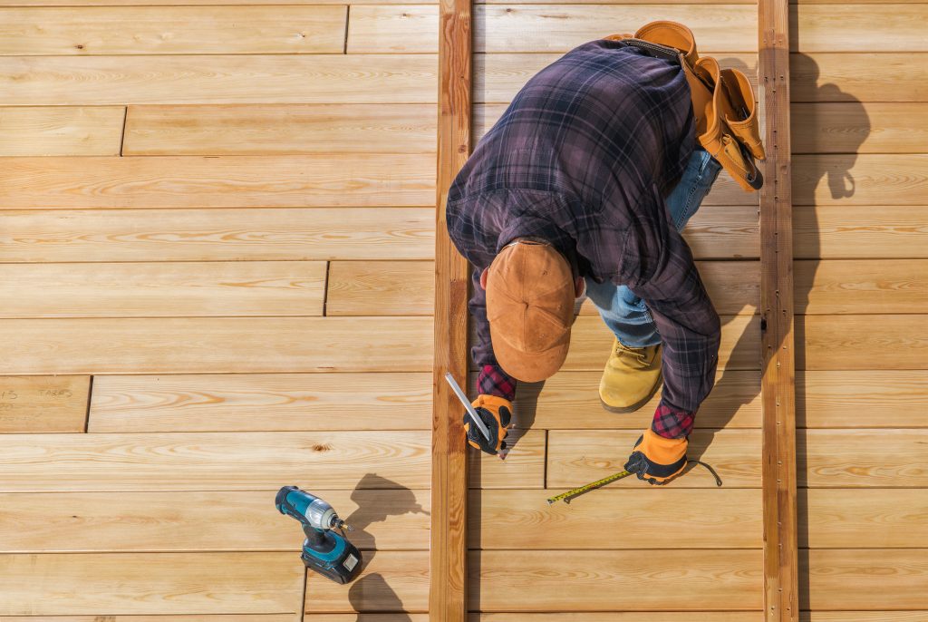Men Building Wooden Decking or new roofing - decking company and driveways Solihull - roof repairs