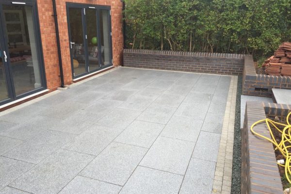Slab patio with buff brick border done by driveways company Coleshill - Patios and driveways Solihull