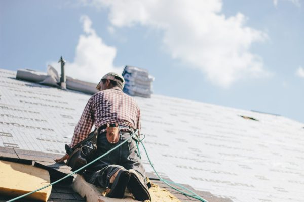 Solihull Roofer adding Shingles to a roof of a house and repointing. Professional roof installers in Solihull.
