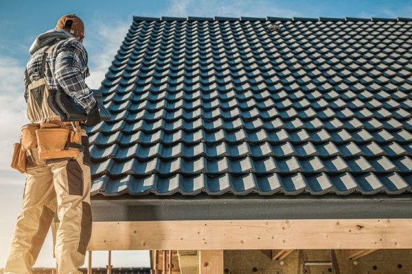 man standing next to Roof tiles, roof repair